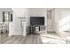 Open-concept living space with a media center, staircase, and light gray flooring creates a comfortable atmosphere at 5782 Knox Ln, Kannapolis, NC 28081
