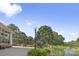 Picturesque view of Village Park featuring a walking path, pond, and lush greenery under a bright sky at 5782 Knox Ln, Kannapolis, NC 28081