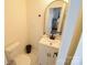 Bathroom boasts an arch mirror, white vanity, and modern fixtures at 62 Fourth St, Cramerton, NC 28032