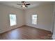 Bright bedroom featuring hardwood floors, a ceiling fan, and natural light from the windows at 62 Fourth St, Cramerton, NC 28032