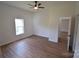 Bedroom featuring a window, ceiling fan, and access to bathroom at 62 Fourth St, Cramerton, NC 28032