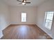 Light-filled bedroom with hardwood floors and two windows providing natural light at 62 Fourth St, Cramerton, NC 28032