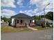 Charming exterior with a wooden porch railing, and landscaped front yard at 62 Fourth St, Cramerton, NC 28032