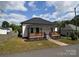 Charming home featuring front porch with wooden railing and fresh landscaping at 62 Fourth St, Cramerton, NC 28032