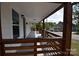 Spacious covered front porch with a wood railing at 62 Fourth St, Cramerton, NC 28032