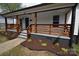 Charming front porch with a wood railing and fresh landscaping at 62 Fourth St, Cramerton, NC 28032
