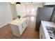 Open-concept kitchen with island, stainless steel refrigerator, and modern sink at 62 Fourth St, Cramerton, NC 28032