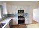 Modern kitchen with stainless steel appliances, sleek cabinetry, and tile backsplash at 62 Fourth St, Cramerton, NC 28032