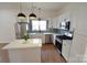 Spacious kitchen with stainless steel appliances, stylish lighting, and ample counter space at 62 Fourth St, Cramerton, NC 28032
