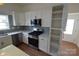 Well-equipped kitchen with stainless appliances, white cabinets, and ample storage at 62 Fourth St, Cramerton, NC 28032