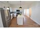 Modern kitchen with stainless steel appliances, white cabinets, and a center island at 62 Fourth St, Cramerton, NC 28032