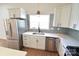 Modern kitchen featuring stainless steel appliances and sleek white cabinetry at 62 Fourth St, Cramerton, NC 28032