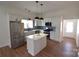 Bright kitchen with stainless steel appliances, stylish lighting, and white cabinetry at 62 Fourth St, Cramerton, NC 28032