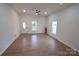 Bright and airy living room with hardwood floors, modern fan, and natural light at 62 Fourth St, Cramerton, NC 28032