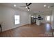 Open-concept living room with a window and a view into the kitchen at 62 Fourth St, Cramerton, NC 28032