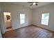 Main bedroom featuring windows, and a door leading to bathroom at 62 Fourth St, Cramerton, NC 28032