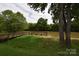 Picturesque pier view from grassy bank, with a calm river surrounded by trees at 62 Fourth St, Cramerton, NC 28032