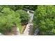 Aerial view of house surrounded by lush trees and a well-manicured landscape at 6736 Raeburn Ln, Charlotte, NC 28227