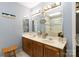This bathroom showcases a dual vanity, decorative mirrors, and a bright glass-enclosed shower at 6736 Raeburn Ln, Charlotte, NC 28227
