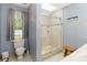 Bright bathroom features a glass-enclosed shower with a pebble floor and a window offering natural light at 6736 Raeburn Ln, Charlotte, NC 28227