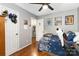 Comfortable bedroom with hardwood flooring, white doors, ceiling fan and natural light at 6736 Raeburn Ln, Charlotte, NC 28227