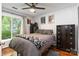 Inviting bedroom featuring hardwood floors, neutral walls, and plenty of natural light at 6736 Raeburn Ln, Charlotte, NC 28227