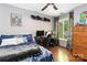 This cozy bedroom includes a ceiling fan, warm wood floors, and a charming street view at 6736 Raeburn Ln, Charlotte, NC 28227