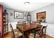 Elegant dining room featuring hardwood floors, wainscoting, and a view into the kitchen at 6736 Raeburn Ln, Charlotte, NC 28227