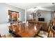 Bright dining area with hardwood floors offering a view to the living area and kitchen at 6736 Raeburn Ln, Charlotte, NC 28227