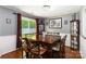 Elegant dining room featuring hardwood floors, wainscoting, and a sliding door to the yard at 6736 Raeburn Ln, Charlotte, NC 28227