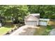 Landscaped front yard and driveway leading to a two-car garage, well maintained garden at 6736 Raeburn Ln, Charlotte, NC 28227