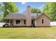 Side view of the house showing backyard and screened in porch, mature lawn at 6736 Raeburn Ln, Charlotte, NC 28227