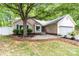 Charming single-story home featuring a well-manicured front yard and cozy entryway bench at 6736 Raeburn Ln, Charlotte, NC 28227