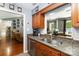Bright kitchen with stainless sink, stone countertops, and wood cabinets at 6736 Raeburn Ln, Charlotte, NC 28227