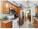 Bright kitchen with stainless steel refrigerator and stove, with wooden cabinets at 6736 Raeburn Ln, Charlotte, NC 28227