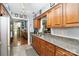 Spacious kitchen with stainless appliances, stone countertops, wood cabinets and tile floors at 6736 Raeburn Ln, Charlotte, NC 28227