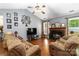 Comfortable living room with vaulted ceiling, cozy fireplace, and plenty of seating at 6736 Raeburn Ln, Charlotte, NC 28227