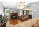 Cozy living room showcasing a fireplace, hardwood floors, and a view into the dining area at 6736 Raeburn Ln, Charlotte, NC 28227