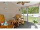 Inviting screened porch with two rocking chairs and decor accents. Great view of the yard at 6736 Raeburn Ln, Charlotte, NC 28227