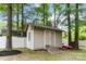 Backyard shed near the house, surrounded by trees and a fenced in yard at 6736 Raeburn Ln, Charlotte, NC 28227
