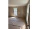 Bedroom featuring wood paneled walls, two windows and a doorway at 723 Pee Dee Ave, Albemarle, NC 28001