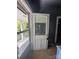 Old entryway with a partial view of the exterior through a window at 723 Pee Dee Ave, Albemarle, NC 28001