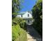 Charming two-story home with a metal roof and mature trees in a lush yard at 723 Pee Dee Ave, Albemarle, NC 28001