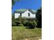 Classic home with a green metal roof and lush surrounding landscape at 723 Pee Dee Ave, Albemarle, NC 28001
