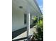 Inviting front porch with white columns and a classic light fixture at 723 Pee Dee Ave, Albemarle, NC 28001