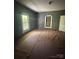 A room with a view of two windows and paint-covered floors at 723 Pee Dee Ave, Albemarle, NC 28001