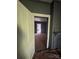 A room view through the doorway, featuring paint-covered floors leading into an adjoining room at 723 Pee Dee Ave, Albemarle, NC 28001