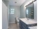 Well-lit bathroom with a window, shower, and vanity with open shelving at 744 Chipmeadow Ln, York, SC 29745