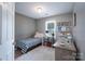Cozy bedroom featuring a striped bed, white rug, and book shelf at 744 Chipmeadow Ln, York, SC 29745