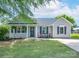 Charming single story home with a well manicured lawn, covered porch, and inviting curb appeal at 744 Chipmeadow Ln, York, SC 29745